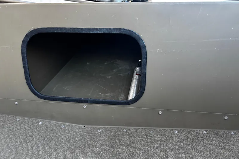 Slide: The Image of 2025 G3 Gator Tough 1652 VBW boat storage compartment with open hatch. - 42