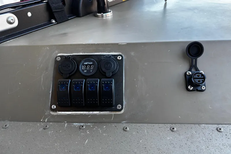 Slide: The Image of Control panel on 2025 G3 Gator Tough 1652 VBW boat, featuring voltage display and switches. - 43
