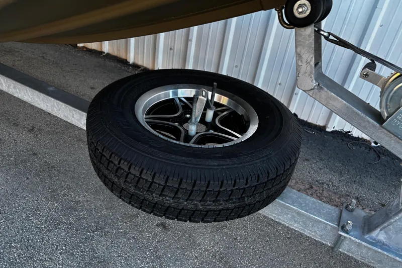 Slide: The Image of Trailer wheel of 2025 G3 Gator Tough 1652 VBW boat, parked on asphalt. - 46