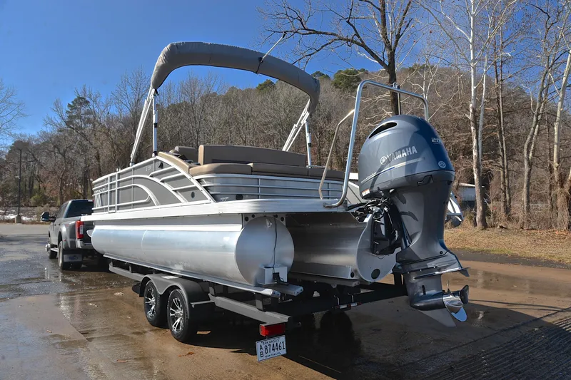 Slide: The Image of 2023 Bennington L23 pontoon boat with Yamaha engine on trailer, parked outdoors. - 12