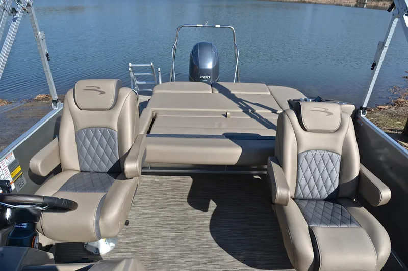 Slide: The Image of 2023 Bennington L23 boat interior with luxurious seating and lake view. - 23