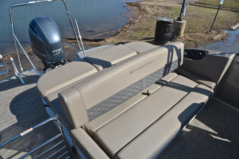 Slide: The Image of 2023 Bennington L23 pontoon boat with comfortable seating and powerful outboard motor. - 24