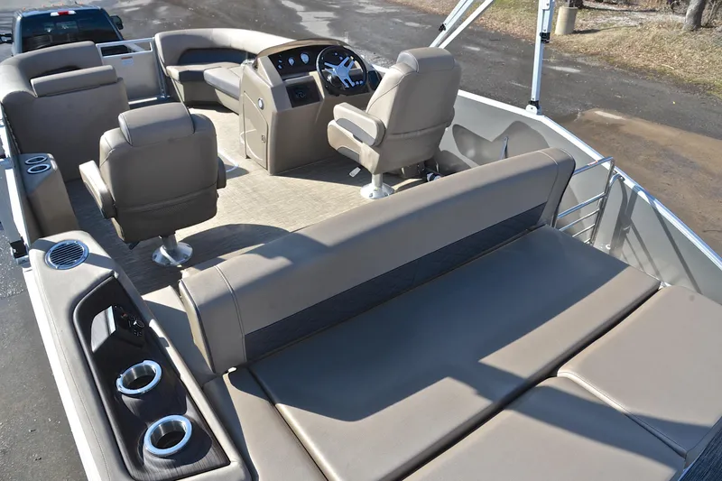 Slide: The Image of 2023 Bennington L23 pontoon boat interior with plush seating and modern helm. - 25