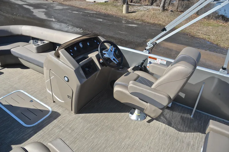 Slide: The Image of 2023 Bennington L23 boat interior with captain's chair and control console. - 26