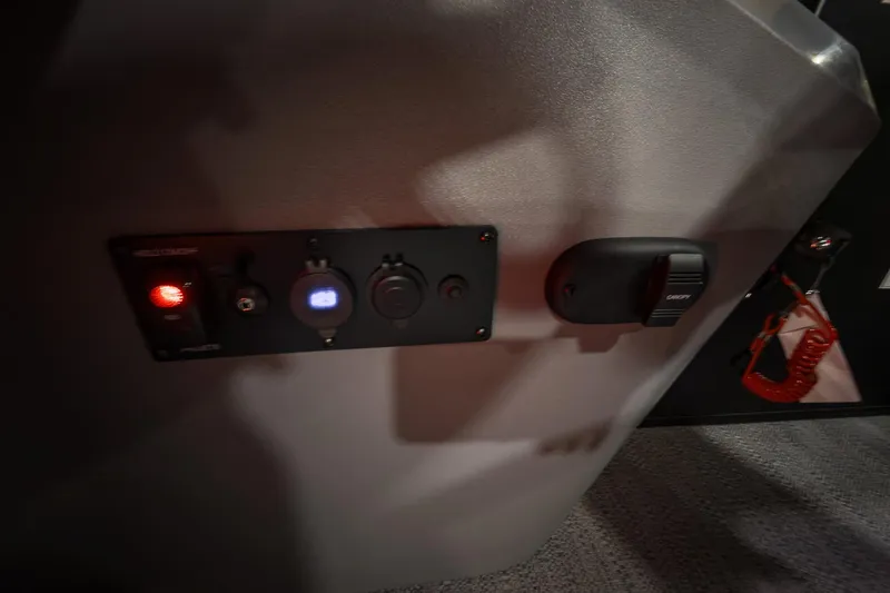 Slide: The Image of Control panel of 2026 Godfrey Sweetwater 22' Tritoon boat with switches and safety features. - 13