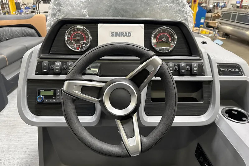 Slide: The Image of Steering console of 2026 Godfrey Sweetwater 22' Tritoon with modern controls and gauges. - 40