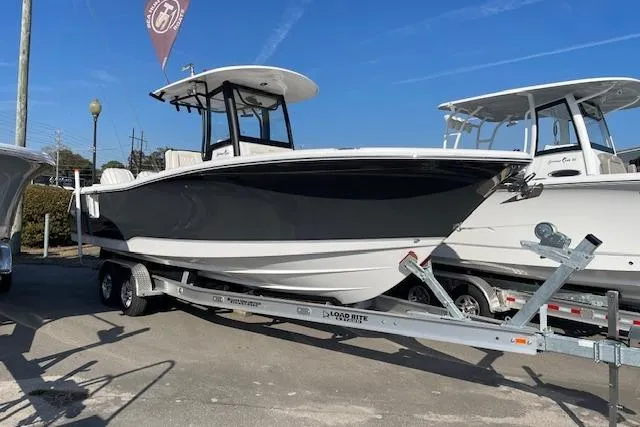 The Image of 2026 Sea Hunt Gamefish 27 Coffin Box boat on trailer, displayed outdoors. - 1