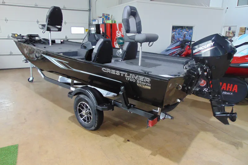The Image of 2026 Crestliner 1700 Storm fishing boat with Mercury outboard motor in showroom. - 1