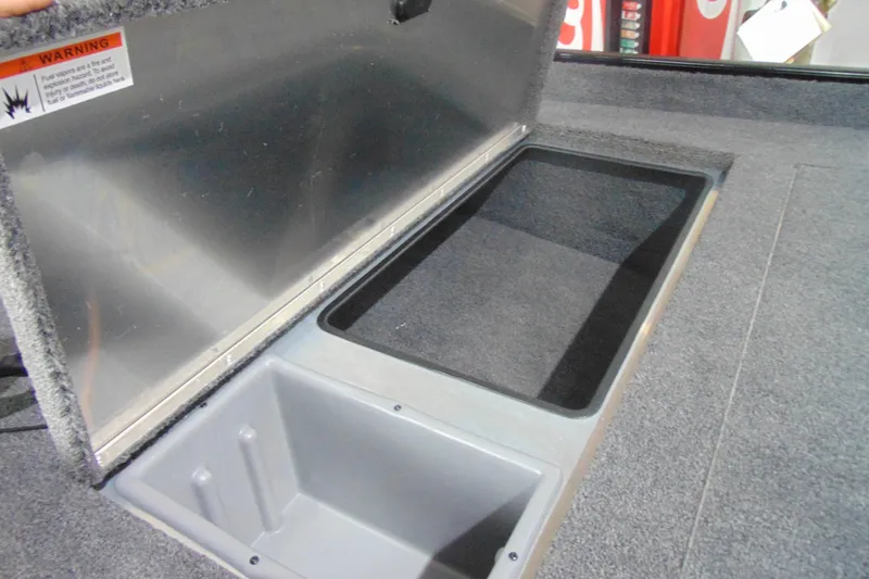 Slide: The Image of Open storage compartment in 2026 Crestliner 1700 Storm boat, featuring carpeted interior. - 8