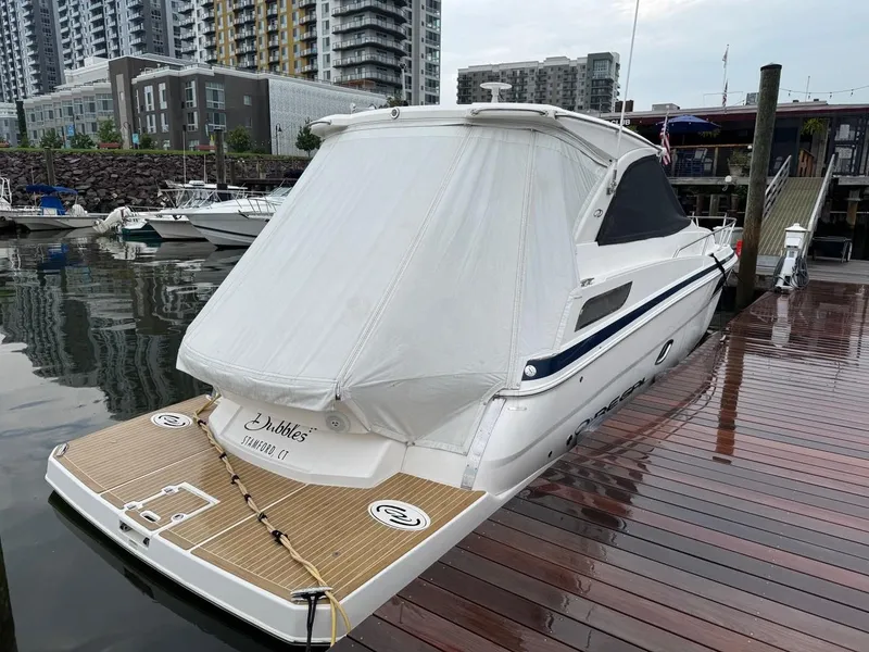 Slide: The Image of 2016 Regal 35 Sport Coupe docked at marina with cityscape background. - 3