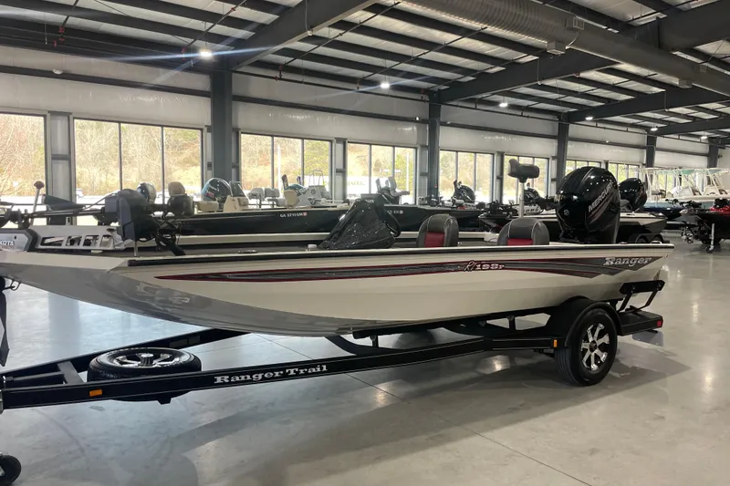 The Image of 2018 Ranger RT198P boat in showroom, on trailer, with visible outboard motor. - 0
