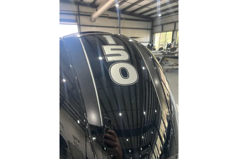 Slide: The Image of 2018 Ranger RT198P boat engine with "150" horsepower marking in a showroom. - 8