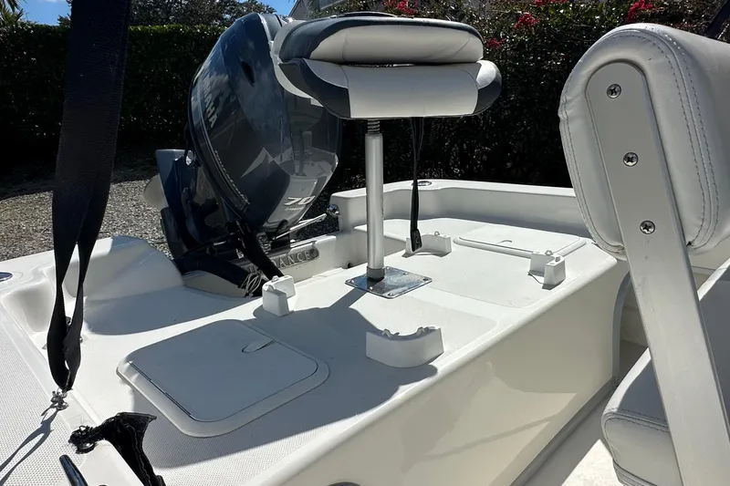 Slide: The Image of 2015 Sundance F19T boat with Yamaha 70 engine, featuring white seating and deck. - 10