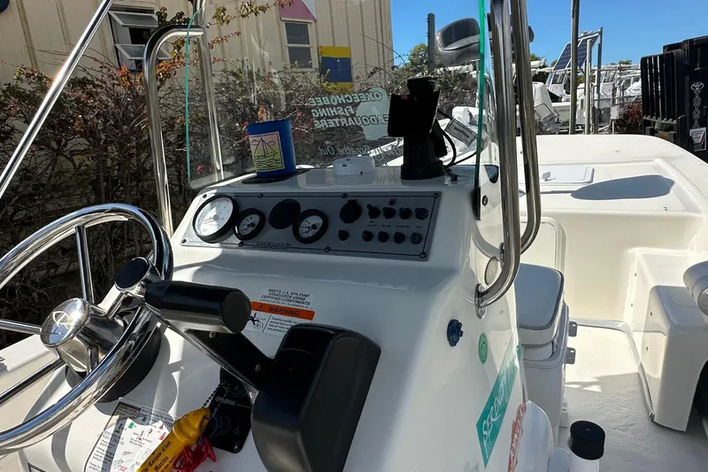 Slide: The Image of 2015 Sundance F19T boat dashboard with steering wheel and control panel. - 6