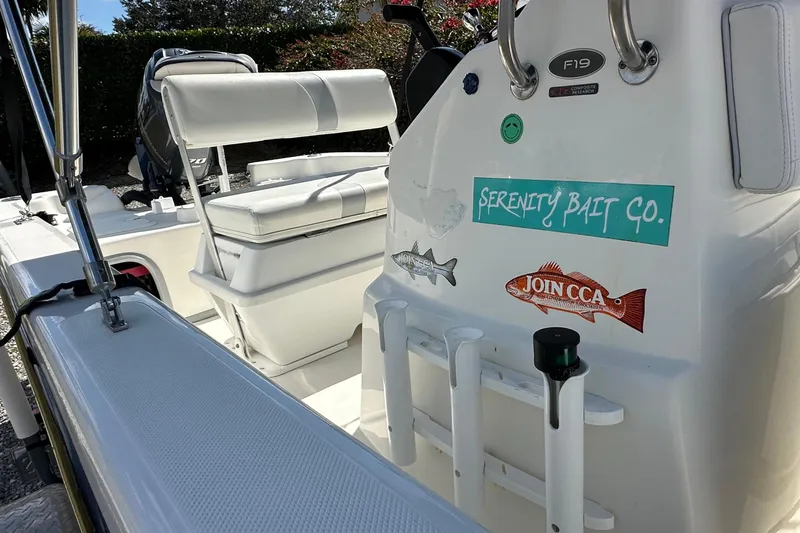 Slide: The Image of 2015 Sundance F19T boat interior with fishing gear and stickers. - 8