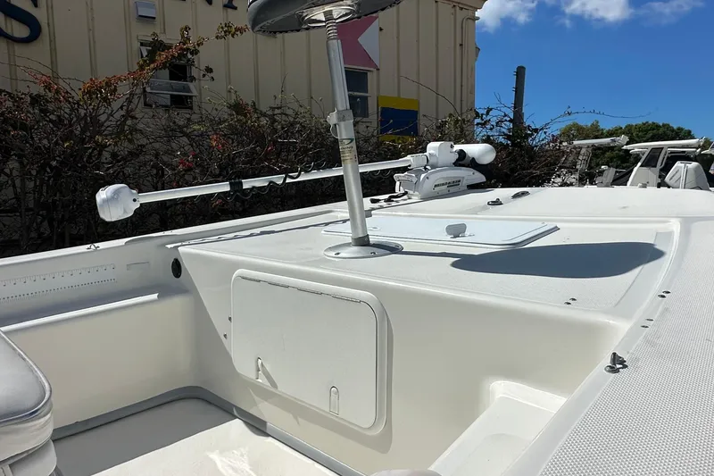 Slide: The Image of 2015 Sundance F19T boat deck with mounted equipment under clear blue sky. - 9