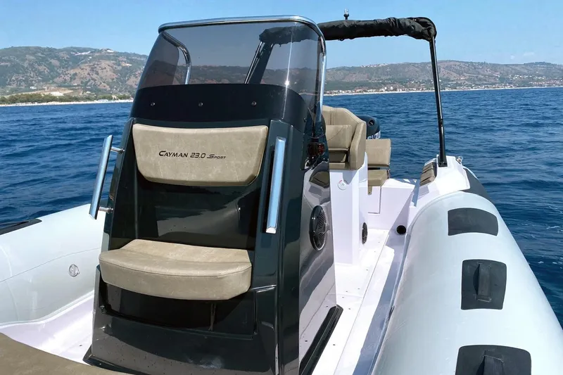 Slide: The Image of 2026 Ranieri Cayman 23.0 Sport boat on open water, featuring sleek design and comfortable seating. - 4