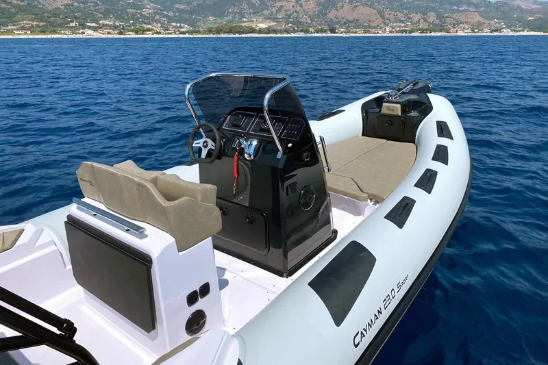 Slide: The Image of 2026 Ranieri Cayman 23.0 Sport boat on blue ocean, showcasing sleek design and modern features. - 5