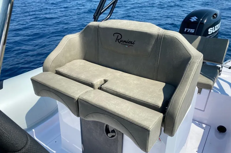 Slide: The Image of 2026 Ranieri Cayman 23.0 Sport boat seat with Suzuki engine on open water. - 9