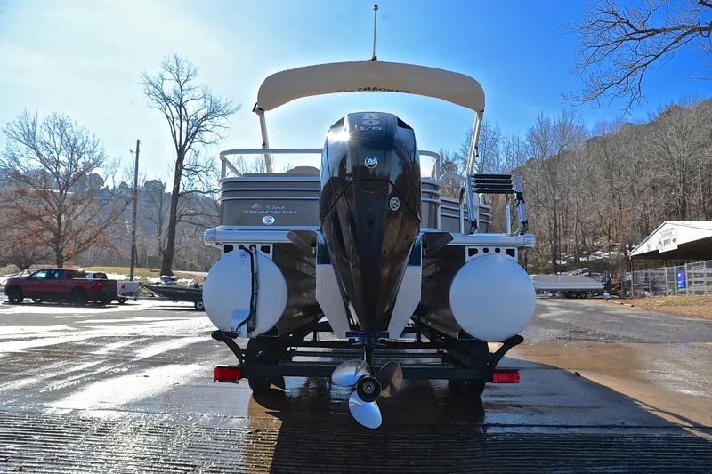 Slide: The Image of 2023 Sun Tracker SportFish 22 XP3 pontoon boat with outboard motor, parked on a sunny day. - 13