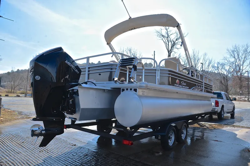 Slide: The Image of 2023 Sun Tracker SportFish 22 XP3 pontoon boat on trailer, parked outdoors. - 14