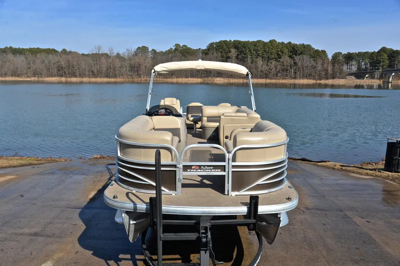 Slide: The Image of 2023 Sun Tracker SportFish 22 XP3 pontoon boat on a serene lake backdrop. - 17