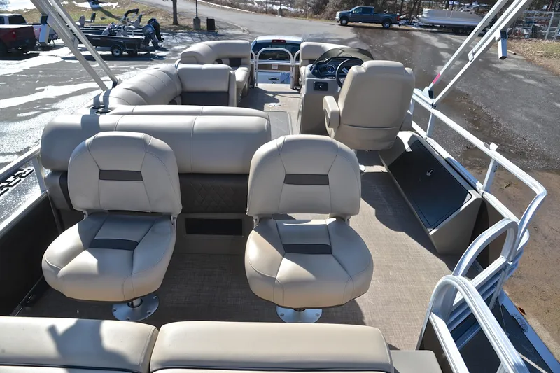 Slide: The Image of 2023 Sun Tracker SportFish 22 XP3 pontoon boat interior with beige seating and steering console. - 18