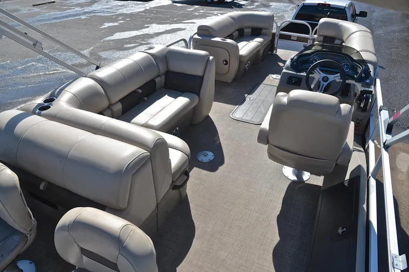 Slide: The Image of 2023 Sun Tracker SportFish 22 XP3 pontoon boat interior with plush seating and steering console. - 19