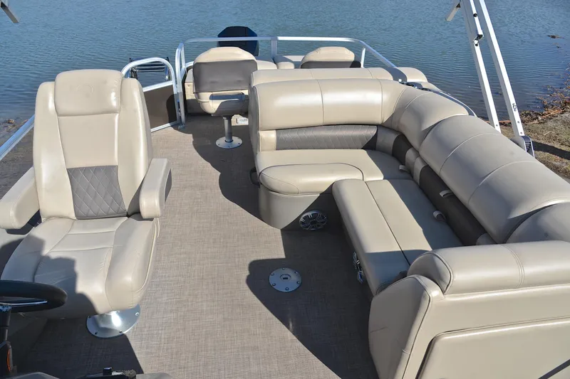 Slide: The Image of 2023 Sun Tracker SportFish 22 XP3 pontoon boat interior with beige seating and water view. - 23