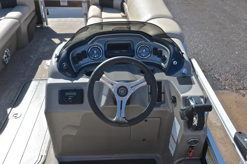 Slide: The Image of 2023 Sun Tracker SportFish 22 XP3 boat dashboard with steering wheel and controls. - 26