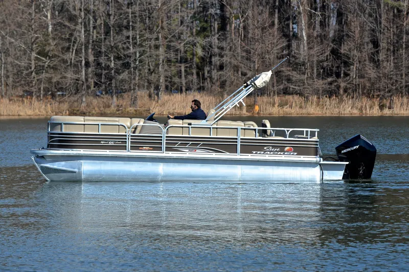 Slide: The Image of 2023 Sun Tracker SportFish 22 XP3 pontoon boat on a calm lake. - 7