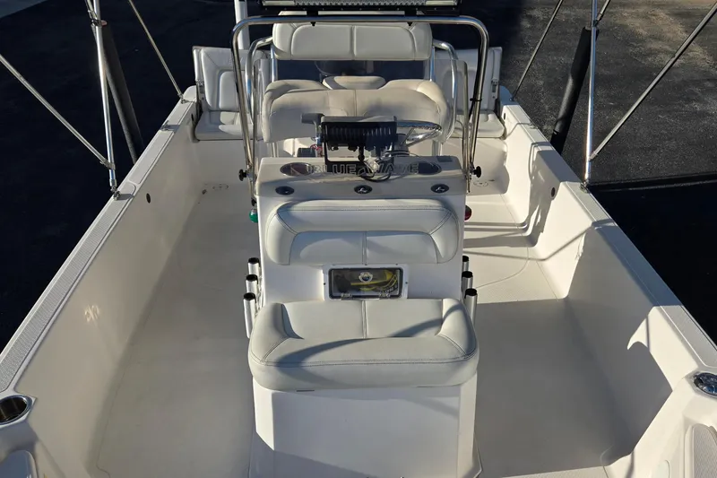 Slide: The Image of 2016 Blue Wave 1900 STL boat interior with white seating and console. - 13