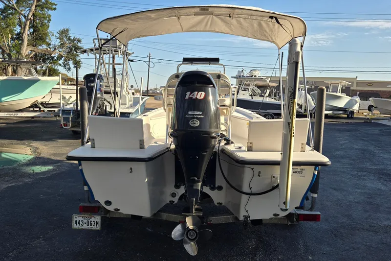 Slide: The Image of 2016 Blue Wave 1900 STL boat with 140 HP engine, parked in a marina. - 4