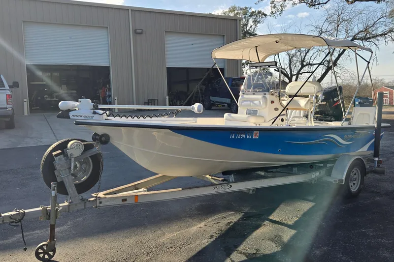 Slide: The Image of 2016 Blue Wave 1900 STL boat on trailer outside a garage. - 7