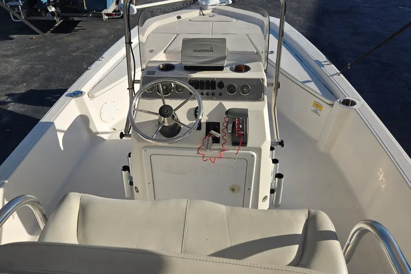 Slide: The Image of 2016 Blue Wave 1900 STL boat interior with steering wheel and Garmin navigation system. - 9