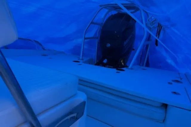 Slide: The Image of 2015 Boston Whaler 180 Dauntless boat interior under blue cover. - 8