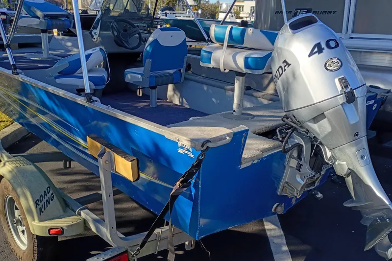 Slide: The Image of 2009 Monark Vision 1601 SC boat with Honda 40 outboard motor on trailer. - 2