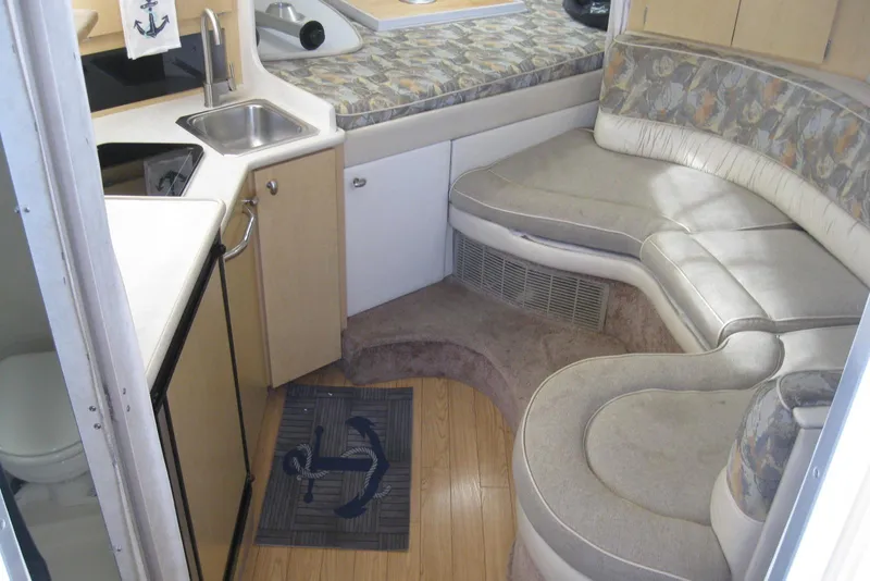 Slide: The Image of 2000 Bayliner 3055 Ciera Sunbridge DX/LX interior with kitchenette and curved seating area. - 17