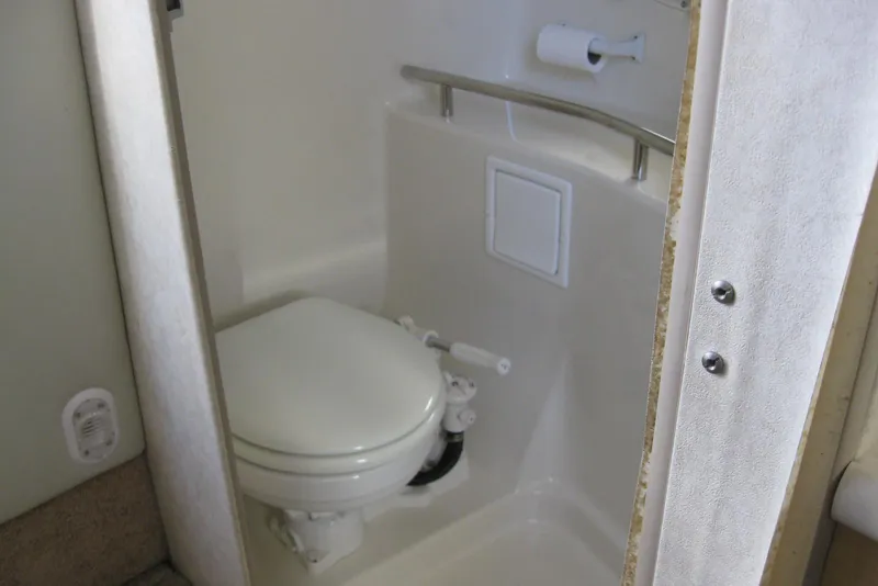 Slide: The Image of Compact bathroom in 2000 Bayliner 3055 Ciera Sunbridge DX/LX boat. - 23