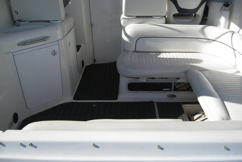 Slide: The Image of 2000 Bayliner 3055 Ciera Sunbridge DX/LX interior with white seating and storage compartments. - 8