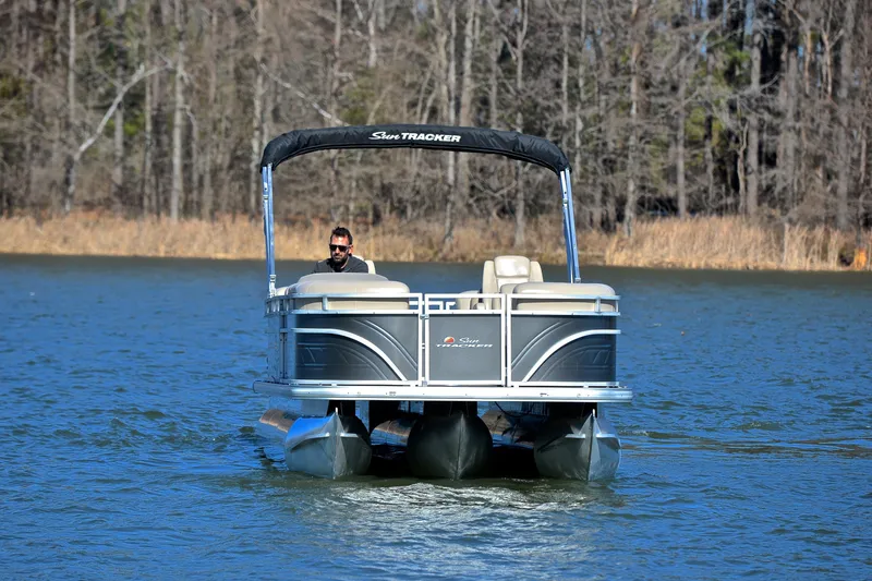 Slide: The Image of 2024 Sun Tracker Party Barge 22 XP3 pontoon boat cruising on a lake. - 10