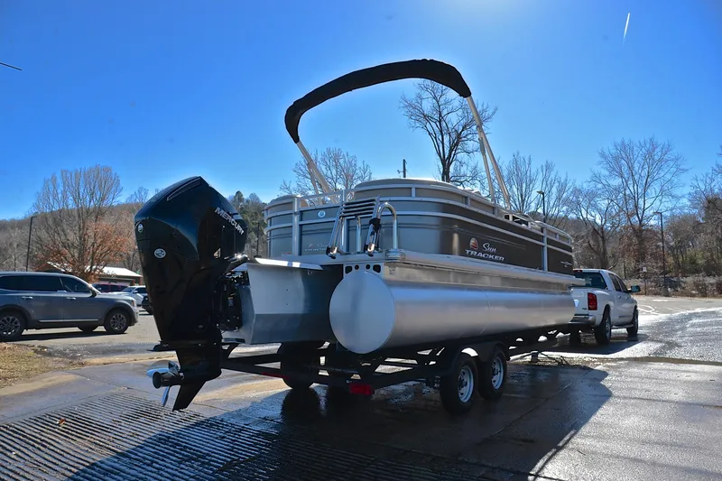 Slide: The Image of 2024 Sun Tracker Party Barge 22 XP3 on trailer, parked outdoors on a sunny day. - 15