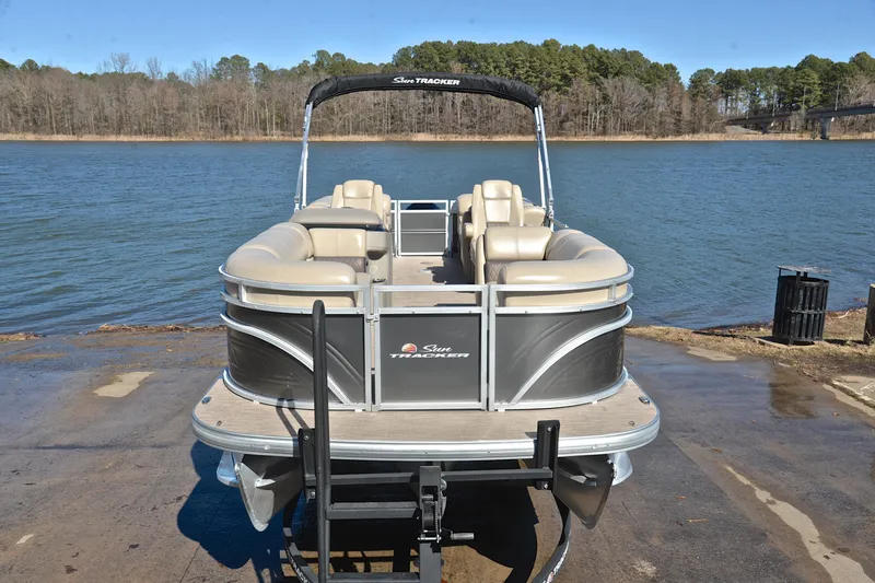 Slide: The Image of 2024 Sun Tracker Party Barge 22 XP3 pontoon boat on a lakefront ramp. - 18