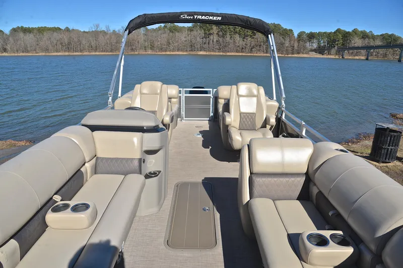 Slide: The Image of 2024 Sun Tracker Party Barge 22 XP3 pontoon boat with spacious seating on a serene lake. - 21