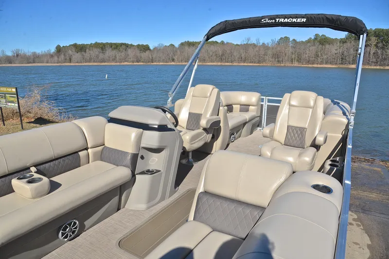 Slide: The Image of 2024 Sun Tracker Party Barge 22 XP3 pontoon boat on a serene lake. - 23