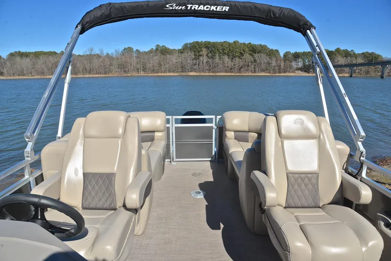 Slide: The Image of 2024 Sun Tracker Party Barge 22 XP3 pontoon boat on a serene lake. - 24