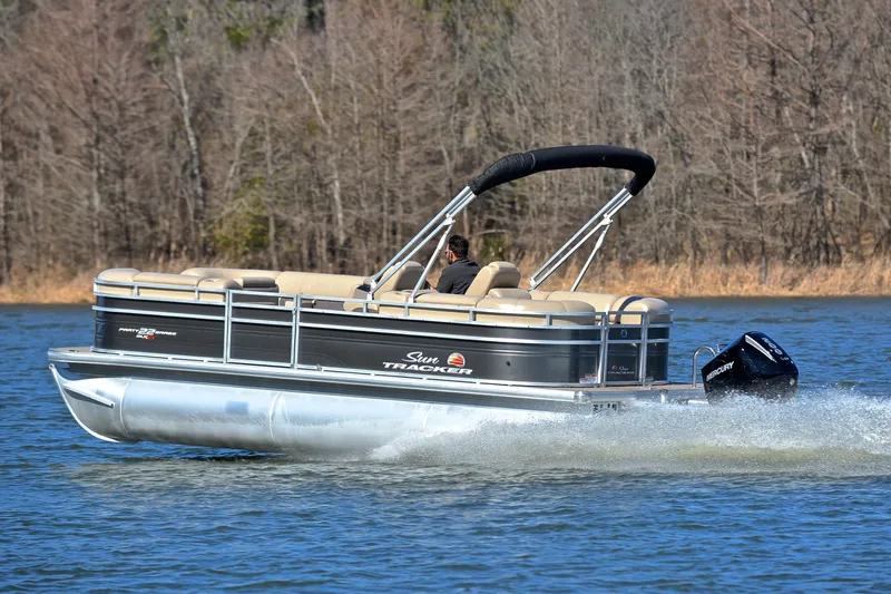 Slide: The Image of 2024 Sun Tracker Party Barge 22 XP3 cruising on a lake with trees in the background. - 5