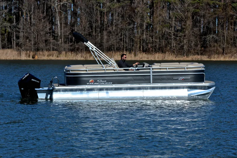 Slide: The Image of 2024 Sun Tracker Party Barge 22 XP3 pontoon boat cruising on a lake. - 7