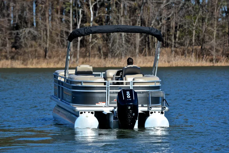 Slide: The Image of 2024 Sun Tracker Party Barge 22 XP3 pontoon boat on a serene lake. - 8