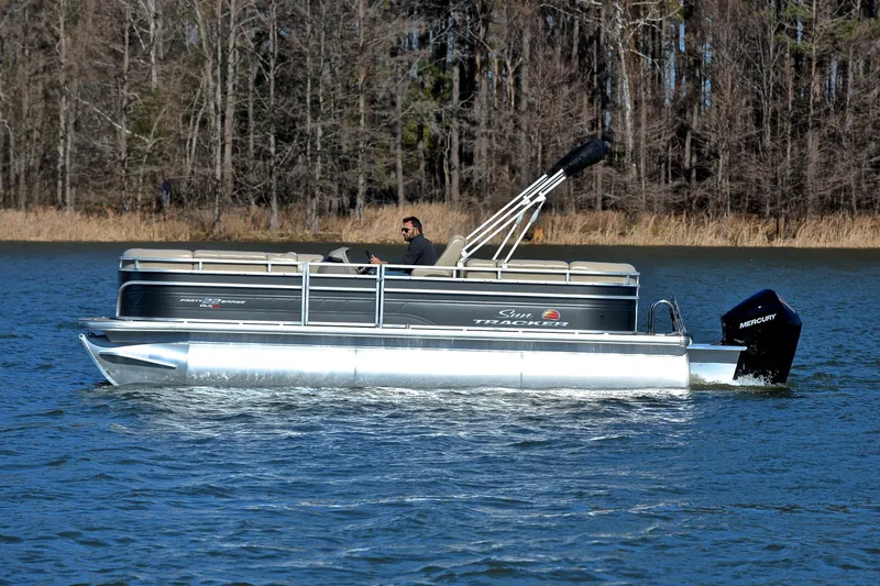 Slide: The Image of 2024 Sun Tracker Party Barge 22 XP3 pontoon boat cruising on a lake. - 9